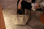 Beige sherpa tote bag styled outdoors as a minimalist fashion handbag